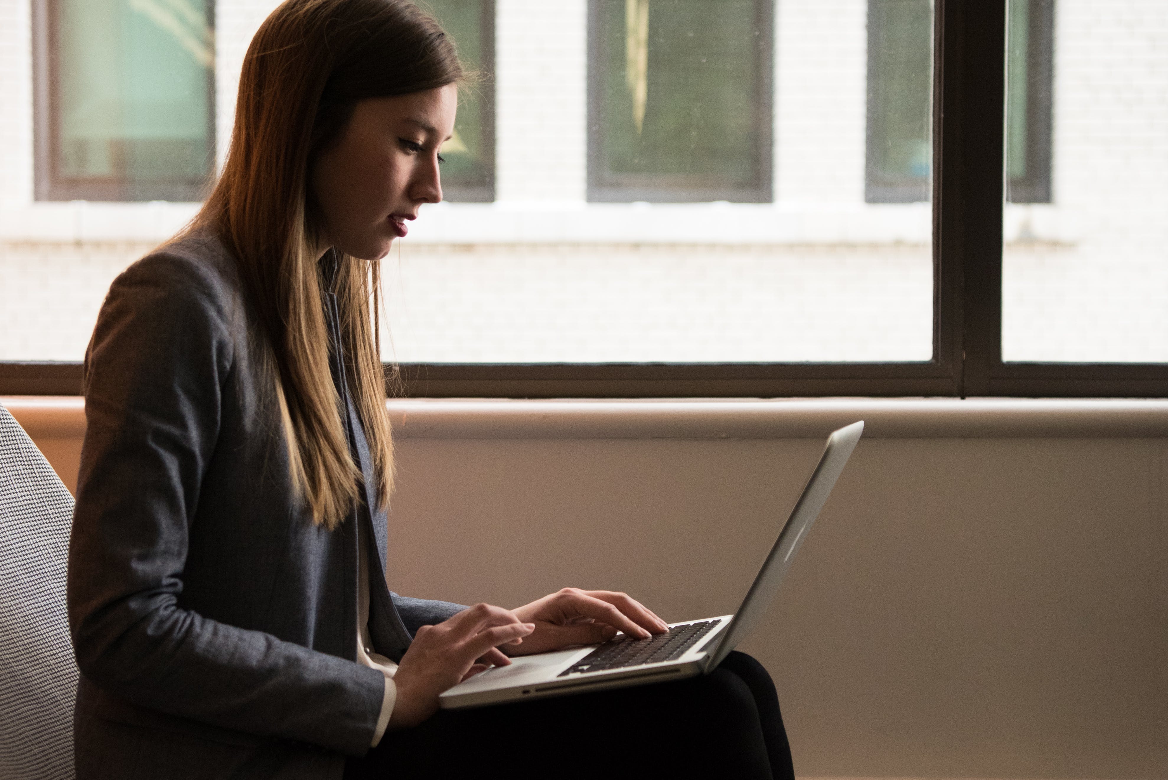 Woman using laptop to send emails